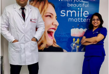 Dental specialists at Jehangir Oracare Dental Care Centre Pune standing beside a smile care display, showcasing advanced dental treatments and expert oral healthcare services.