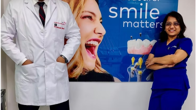 Dental specialists at Jehangir Oracare Dental Care Centre Pune standing beside a smile care display, showcasing advanced dental treatments and expert oral healthcare services.