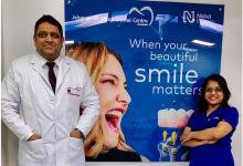 Dental specialists at Jehangir Oracare Dental Care Centre Pune standing beside a smile care display, showcasing advanced dental treatments and expert oral healthcare services.