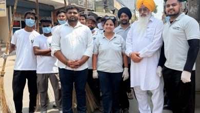 Volunteers of Gauri Shankar Social Foundation and Kaashh Magic Foundation posing during a cleanliness campaign in Chander Vihar, Delhi, with community members and social leaders holding cleaning tools.